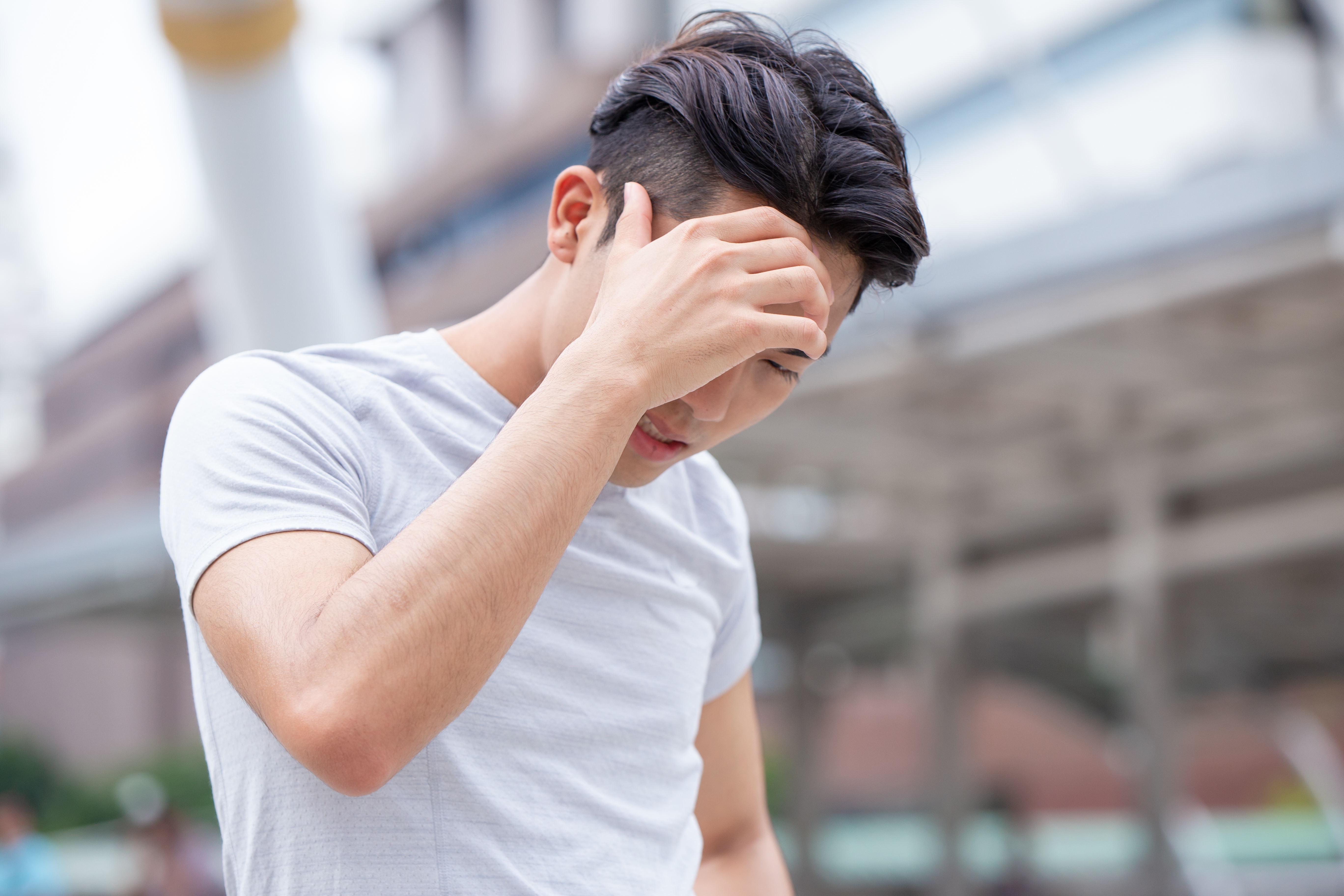 Young man appear to be having headache