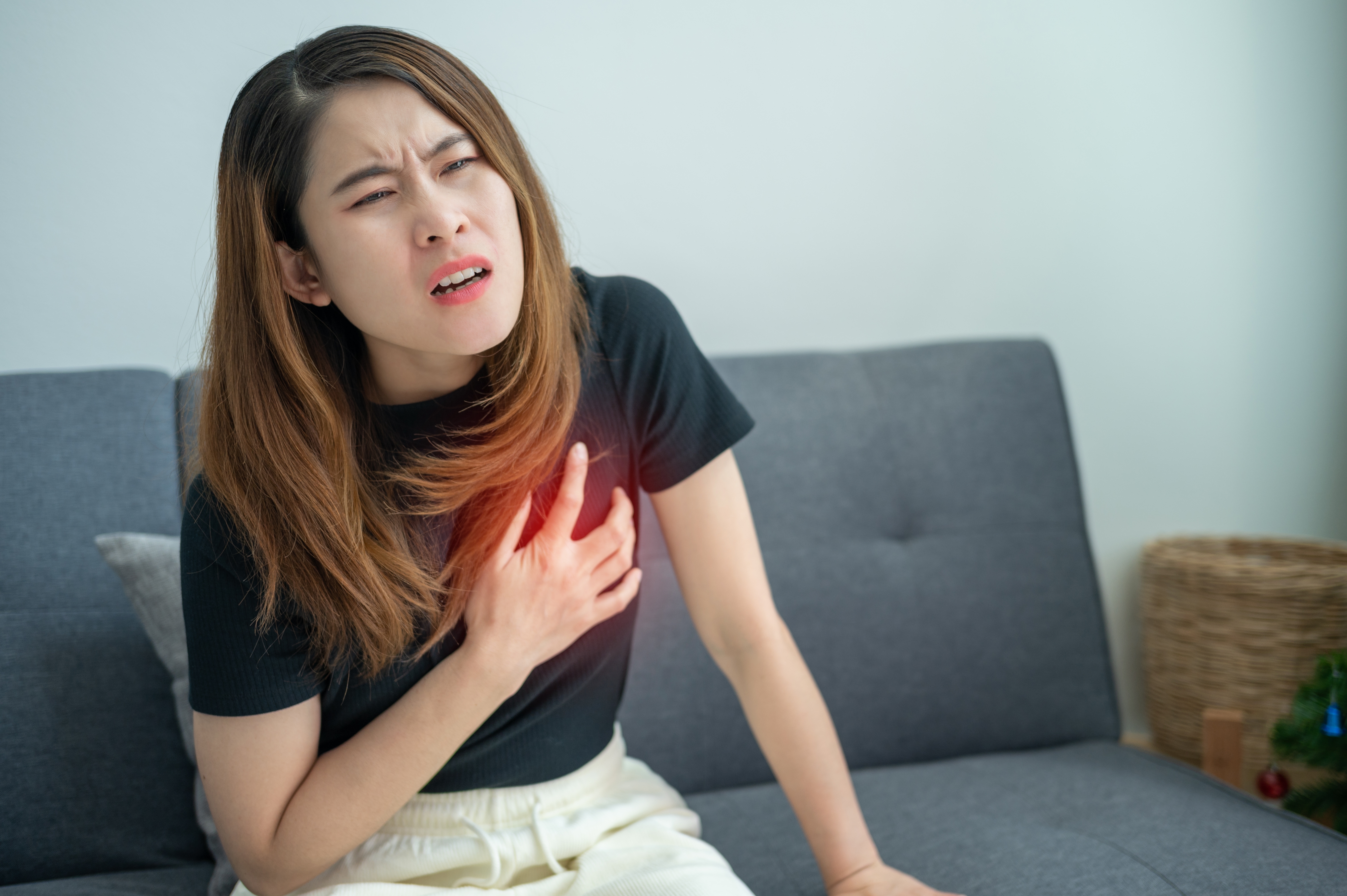 Young woman clutching her chest