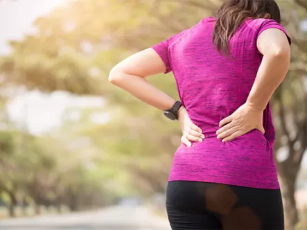 Tired Young Asian Sport girl feel pain on her back and hip