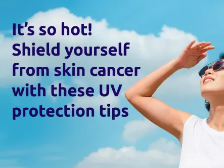 An asian woman wearing sunglasses looking up at the hot sun