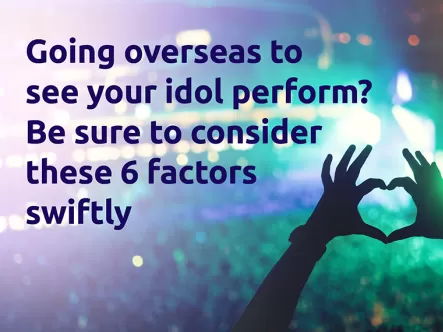 Fan making the heart sign with hands at a big concert