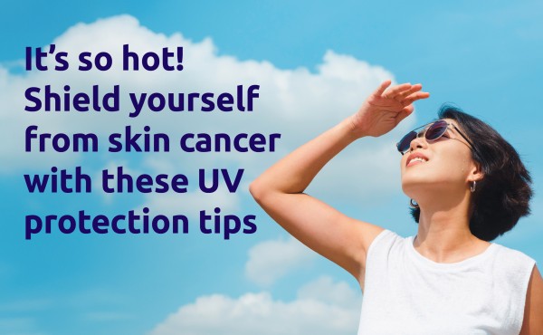 An asian woman wearing sunglasses looking up at the hot sun